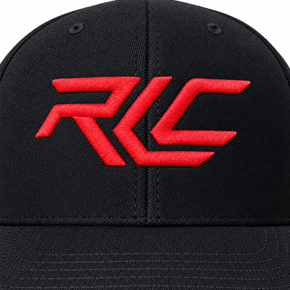 A close-up of a black baseball cap featuring a bold red embroidered 'RCL' logo on the front panel.
