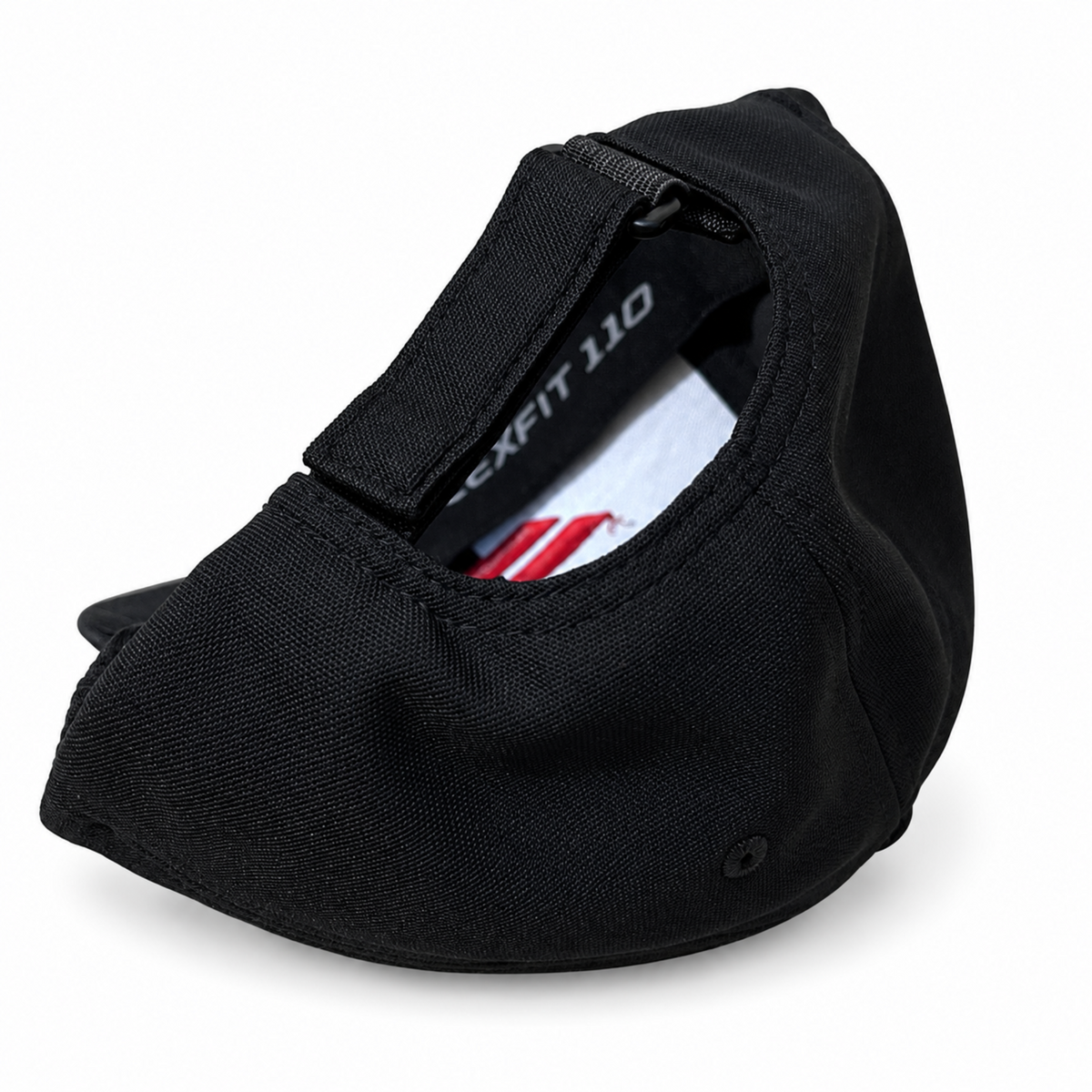 A black fabric cap shown from an angled top view, featuring a hook-and-loop strap closure with 'EXFIT 110' printed on the inner black panel. A white and red striped insert is partially visible inside the crown.