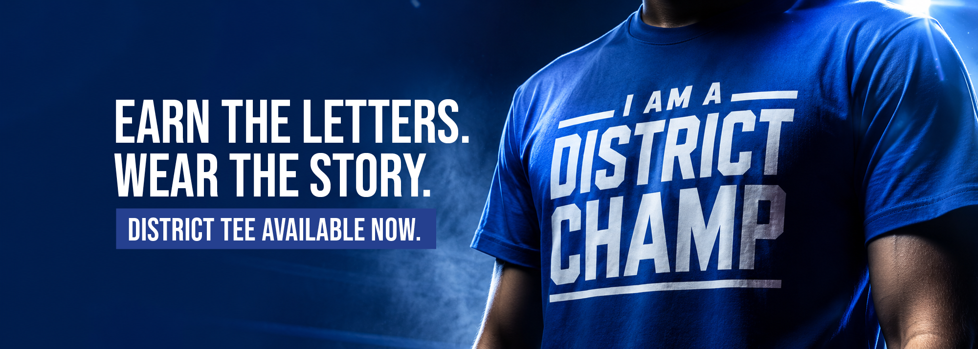 Banner with text "Earn the letters. Wear the story. District Tee Available now." With mockup of a model wearing "I am a District Champ" t-shirt.